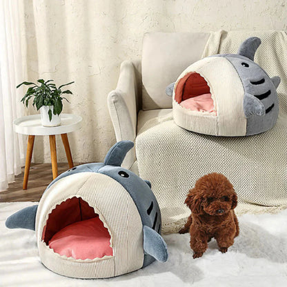 Cute shark-shaped pet bed with a small dog inside, placed on a cozy living room floor.