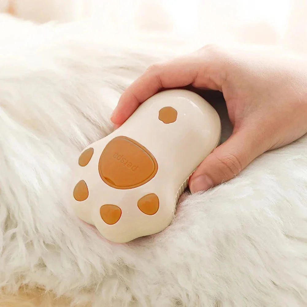 Heart-shaped white and brown product held by a hand on a fluffy white surface